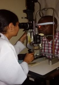 Doctor performing and eye examination on an adult patient